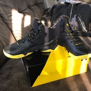 Black trimmed in yellow under armor sneakers